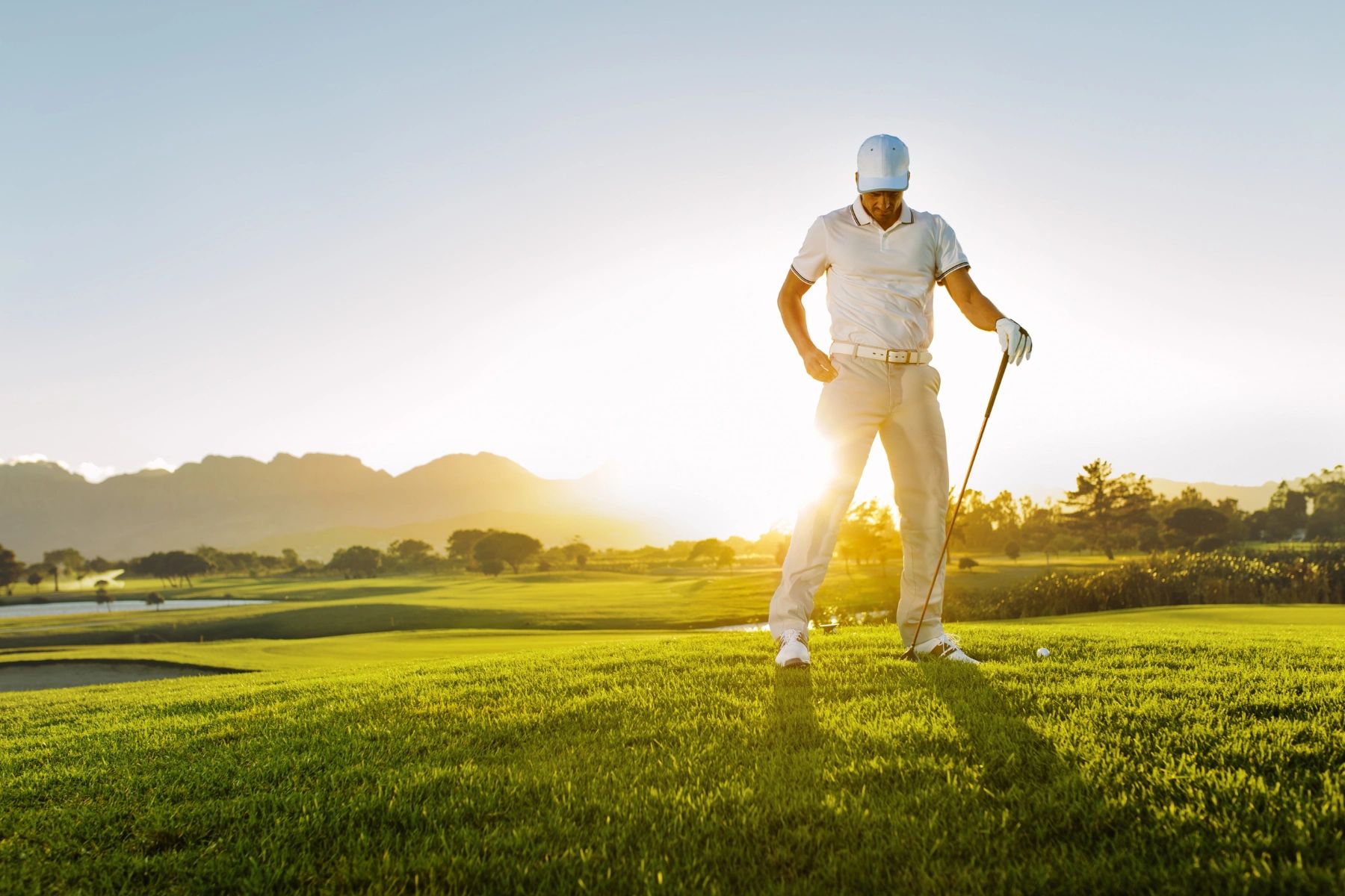 Golfer on a scenic course at sunset